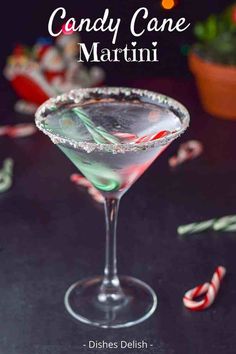 a candy cane martini is garnished with peppermint and sugar on the rim