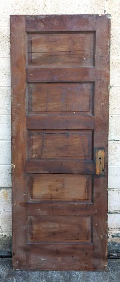 an old wooden door on the side of a building