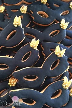 blue and gold decorated doughnuts are arranged in rows on top of each other