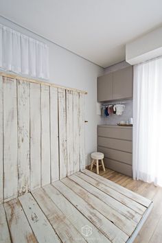 a room with wooden floors and white walls