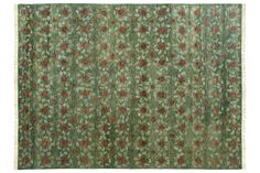 an old rug with red and green flowers on it