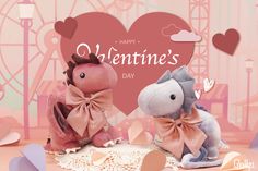 two stuffed animals sitting next to each other in front of a valentine's day card