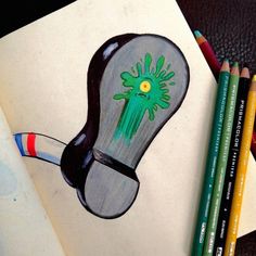 a pencil drawing of a light bulb with green paint on it next to colored pencils