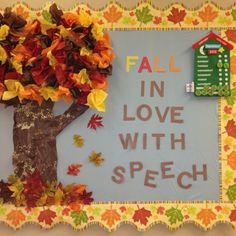 a bulletin board with fall leaves and a tree in the center that says fall in love with speech