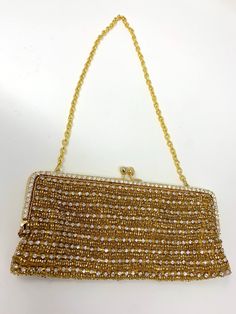 Very glamorous beaded evening bag - Gold-tone with rhinestones. In very, very good condition. Measures 8 inches across the bottom and 4 inches high Great for any formal event Glamorous Rhinestone-embellished Handheld Evening Bag, Glamorous Rhinestones Handheld Evening Bag, Handheld Rhinestone Evening Bag For Formal Events, Glamorous Beaded Evening Bag For Formal Occasions, Glamorous Beaded Evening Bag For Formal Events, Glamorous Beaded Formal Shoulder Bag, Gold Evening Bag With Rhinestones For Formal Events, Gold Evening Bag With Rhinestones For Formal Occasions, Bling Handheld Evening Bag