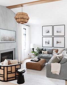 a living room filled with furniture and pictures on the wall