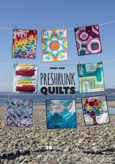 there are many quilts hanging on the clothes line with words preshrunk quilts