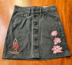 "This Chakra and Lotus Hand Embroidered Black Jean Skirt is the perfect way to make a statement. It is made from a high-quality denim fabric and features intricate hand-embroidered details. The size 000 is perfect for petite ladies, offering a flattering fit that will make you look and feel amazing. The unique design is sure to turn heads and is sure to become a favorite in your wardrobe. PLEASE NOTE: This skirt is a dark black. Much darker than the pictures. 23\" Waist, Super Hi-Rise Aline. Len Witchy Skirt, Hand Embroidered Skirt, Jean Clothes, Black Jean Skirt, Blue Jean Skirt, Embroidered Skirt, Black Denim Jeans, Jeans Rock, Womens Jeans