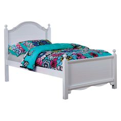 a white bed with blue and pink comforter on it's headboard, in front of a white background