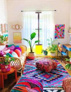 a living room filled with lots of colorful furniture and art on the wall above it