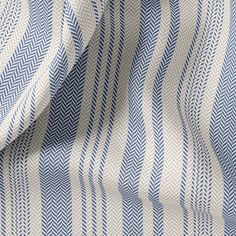 a blue and white striped fabric with an interesting design on the front, it is very soft