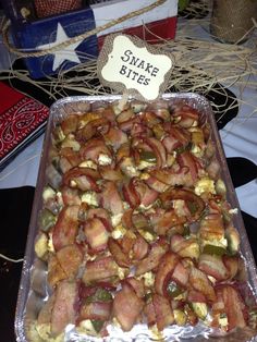 bacon wrapped in cheese and other toppings sits on a table next to an american flag