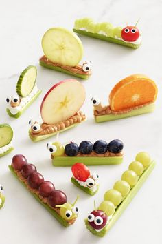 various fruits and veggies are arranged in the shape of caterpillars