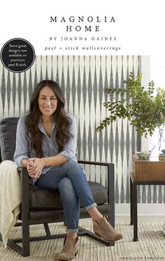 a woman sitting in a chair with her legs crossed, smiling and looking at the camera