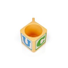 a small wooden toy block with the letter u on it's front and bottom