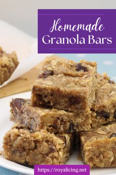 homemade granola bars stacked on top of each other in front of a white plate