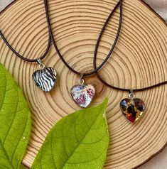 Discover our Animal Print Heart Resin Necklace, featuring a reversible tiny heart pendant that's both stylish and versatile. This handmade piece showcases a bold and bright animal print on one side, while the reverse offers a matte silver color, giving you two unique looks in one elegant necklace. Perfect as an original gift for a special woman, this boho-inspired heart resin necklace is a standout addition to any jewelry collection. Each piece is carefully crafted to ensure its uniqueness, maki Trendy Heart Beads Charm Necklaces As Gift, Trendy Heart Beads Charm Necklace For Gifts, Trendy Charm Necklaces With Heart Beads For Gifts, Trendy Charm Necklace With Heart Beads, Trendy Heart Print Jewelry For Gifts, Trendy Handmade Heart Charm Necklaces, Trendy Heart Charm Necklaces For Gift, Trendy Heart-shaped Charm Necklace Gift, Trendy Heart-shaped Charm Necklaces As Gift