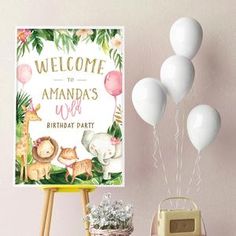 a welcome sign and some balloons on a table