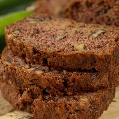 slices of brownie sitting on top of a wooden cutting board next to cucumbers