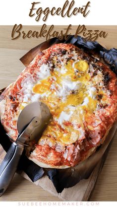 the eggcelt breakfast pizza is ready to be eaten with a spatula and knife