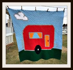 a blue and red quilt hanging from a clothes line