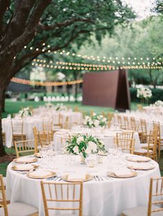 tables and chairs set up for an outdoor wedding reception