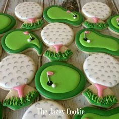 decorated cookies in the shape of golf balls and tees