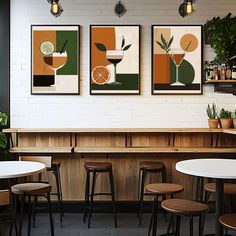 three posters on the wall in a restaurant with bar stools and round tables around them