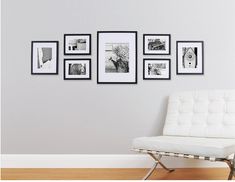 a white chair sitting in front of a wall with pictures on it