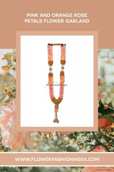 pink and orange rose petal flower garland with tassels on the end, surrounded by flowers