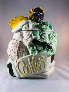 a ceramic figurine that is sitting on top of a cake box with the word cakes written below it