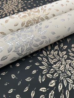 three different types of wallpapers with gold and silver leaves on black, white and grey background