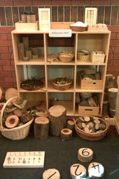 a table topped with lots of different types of wooden items and baskets on top of it