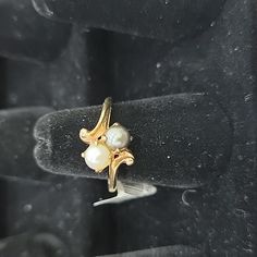 a close up of a ring with pearls on it