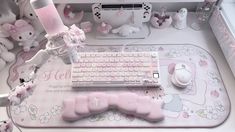 a desk with a keyboard, mouse and stuffed animals on it in a room filled with teddy bears