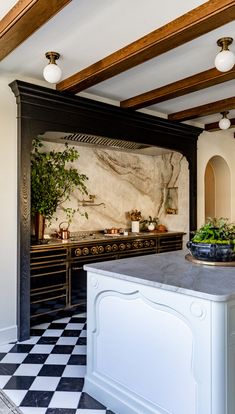 a kitchen with black and white checkered flooring, marble counter tops and an island