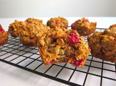 muffins cooling on a wire rack with cranberries and other toppings