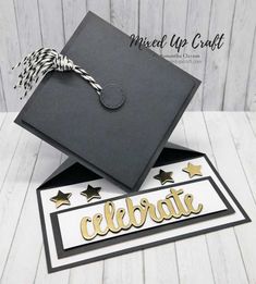 a graduation cap and diploma on top of each other with the word celebrate written in gold