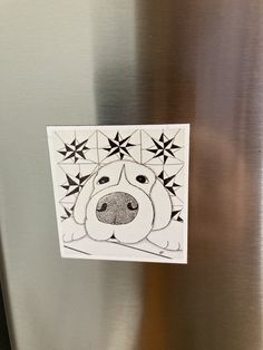 a sticker with a dog's face is on the side of a refrigerator