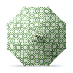 an open green and white umbrella with circles on it's side, against a white background