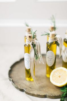 four bottles of lemon essential oil on a tray