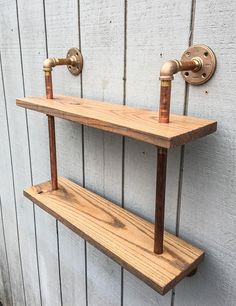 two wooden shelves with brass faucets on them