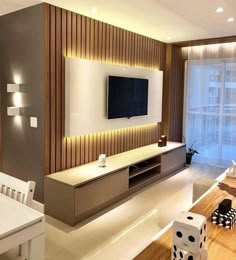 a modern living room with wood paneling and white furniture, along with a flat screen tv mounted on the wall