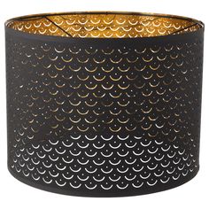 a black lamp shade with gold circles on it