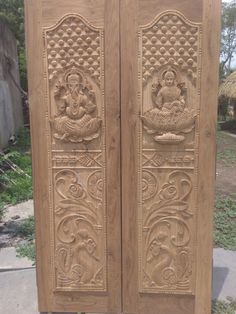 two carved wooden doors sitting next to each other