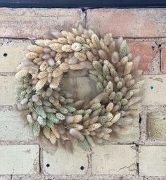 a wreath hanging on the side of a brick wall