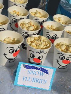 there are many cups with food in them on the table and one has a sign that says snow flurries