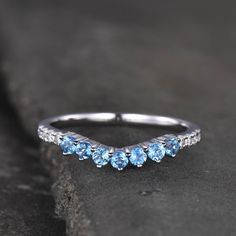 a white gold ring with blue topaz stones