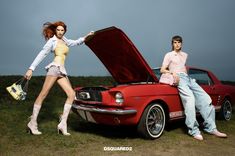 two women sitting on the hood of an old mustang car, one holding a purse