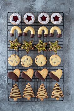 cookies and pastries are arranged on a cooling rack